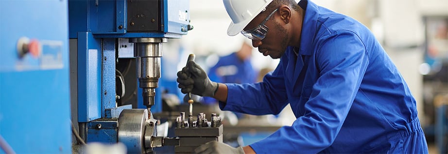 person_repairing_cnc_machine_in_busy_manufacturing_facility_139219