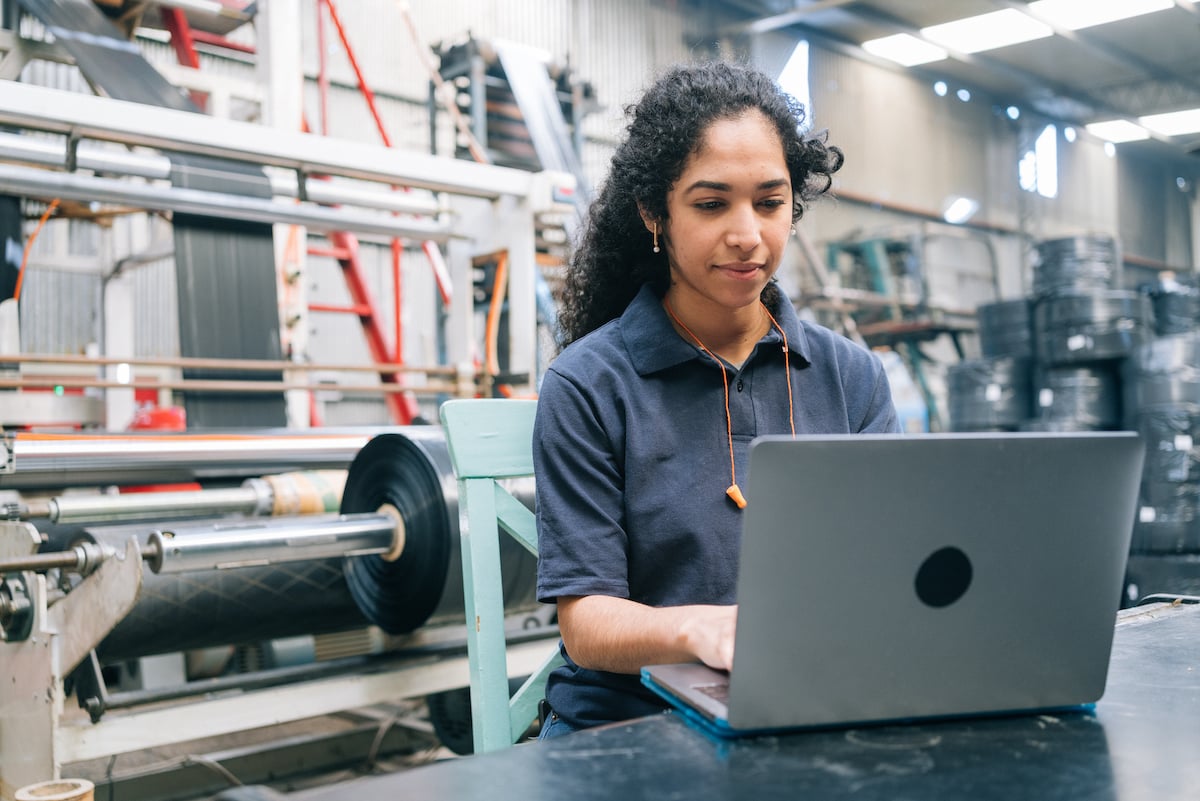 Product line worker testing a sample in a warehouse.